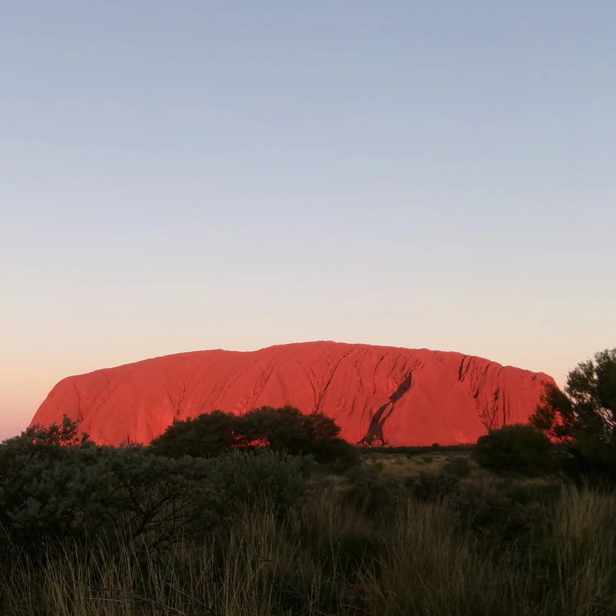 uluru rock formation under clear sky