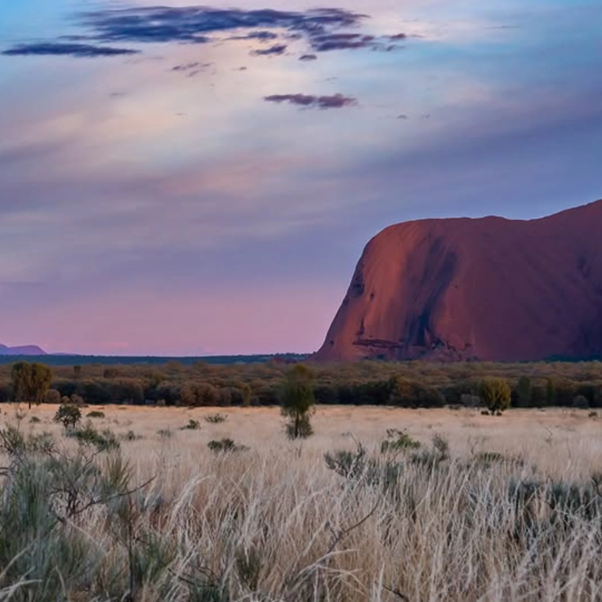 uluru rock formation under clear sky