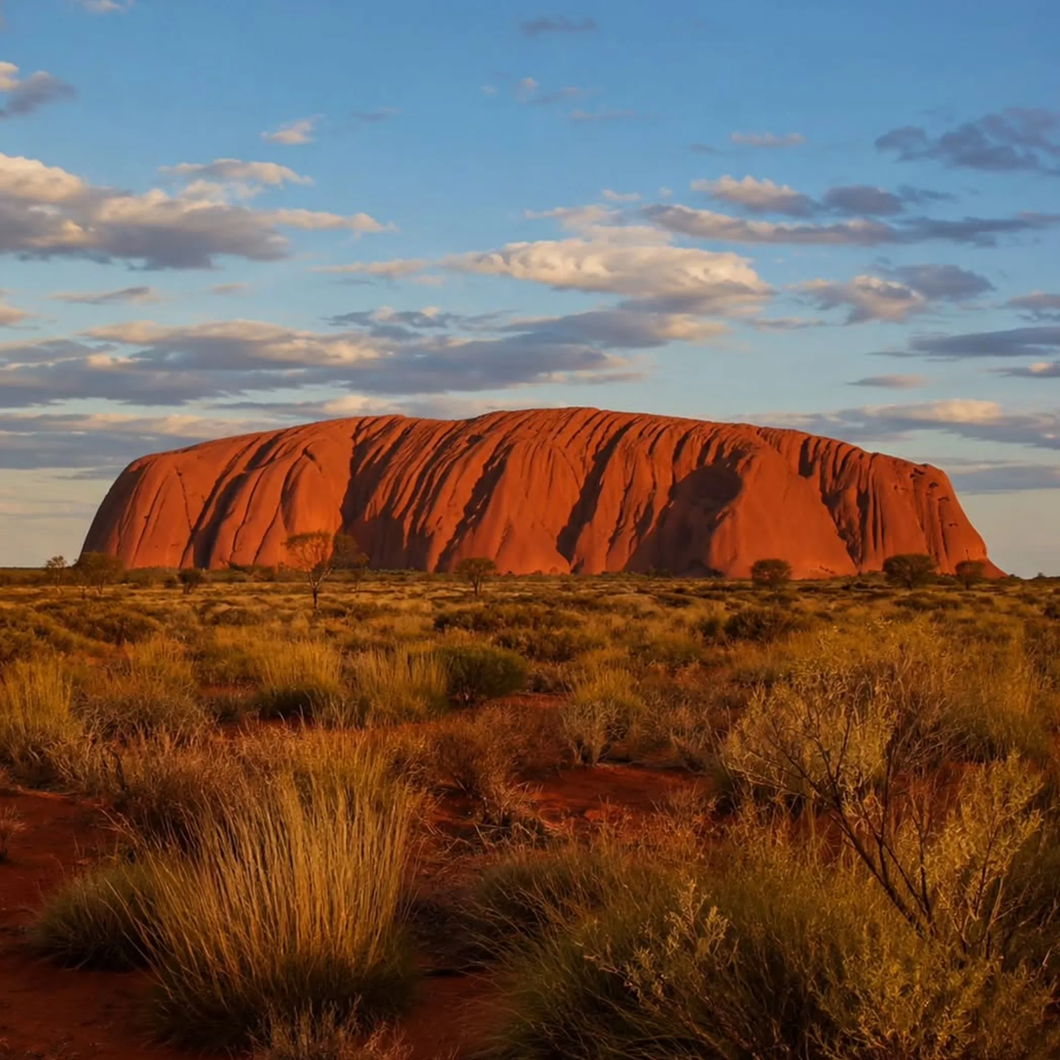 uluru rock formation under clear sky