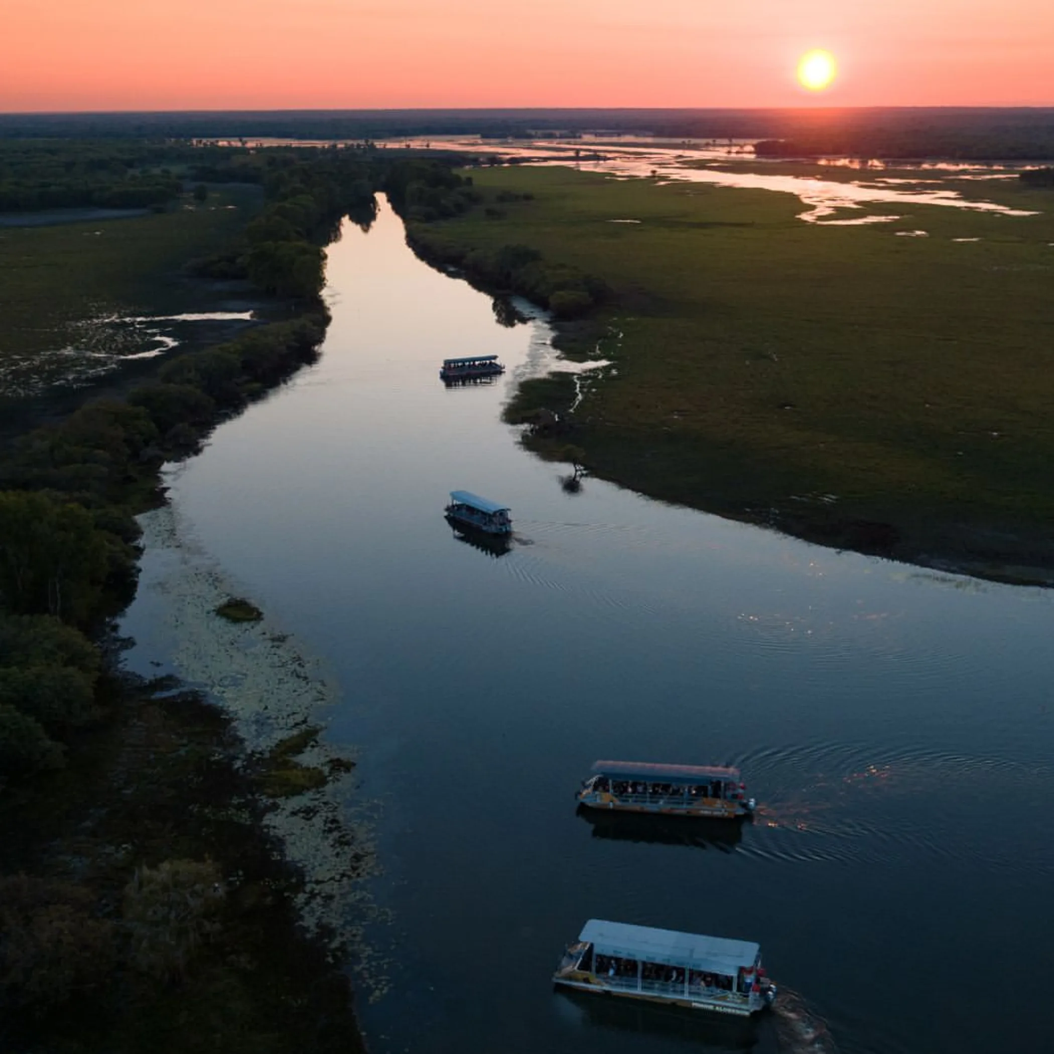 boats on water at kakadu sunset